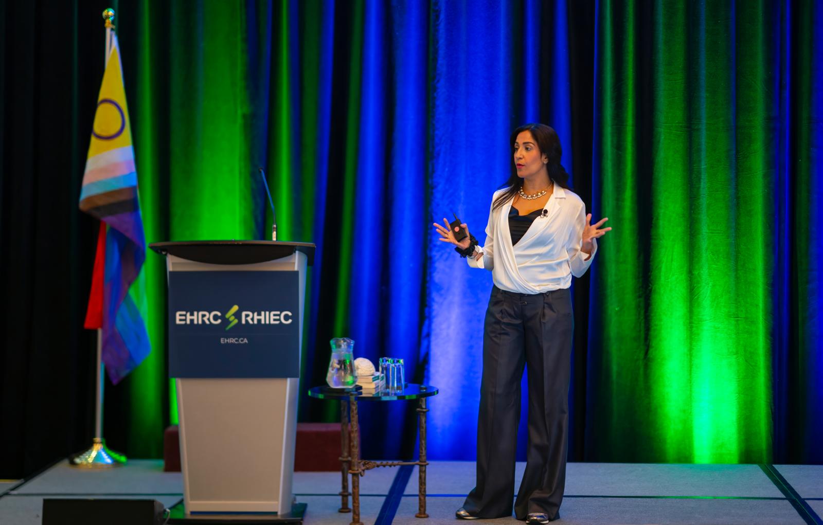 Dr. Shimi Kang speaking on stage
